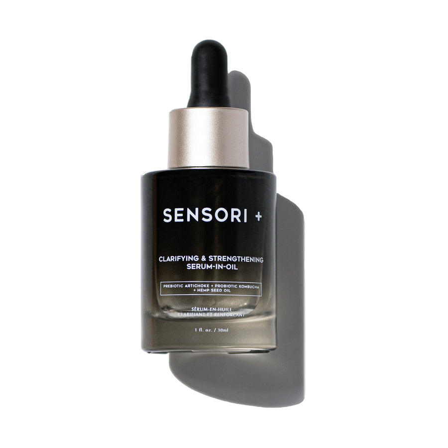 This is a dual-phase facial serum in an olive green glass bottle with a dark rubber tip glass dropper